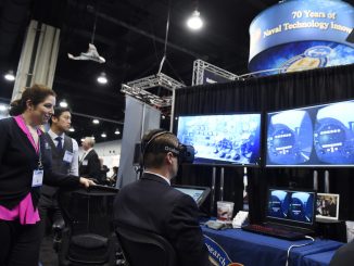 "A vendor explains mixed reality to an attendee at the 2016 Sea-Air-Space Exposition." by Official U.S. Navy Imagery is licensed under CC BY 2.0.